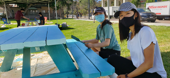 students painting a table